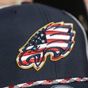 egales logo on the front of the Philadelphia Eagles American Flag Mesh Back Trucker Hat | Navy Trucker Hat