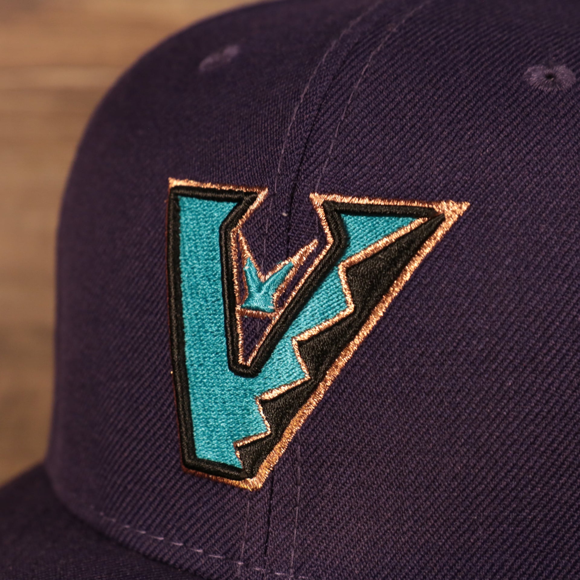 Close up of the front logo on the Arizona Diamondbacks Upside Down Logo Gray Bottom 59Fifty Fitted Cap