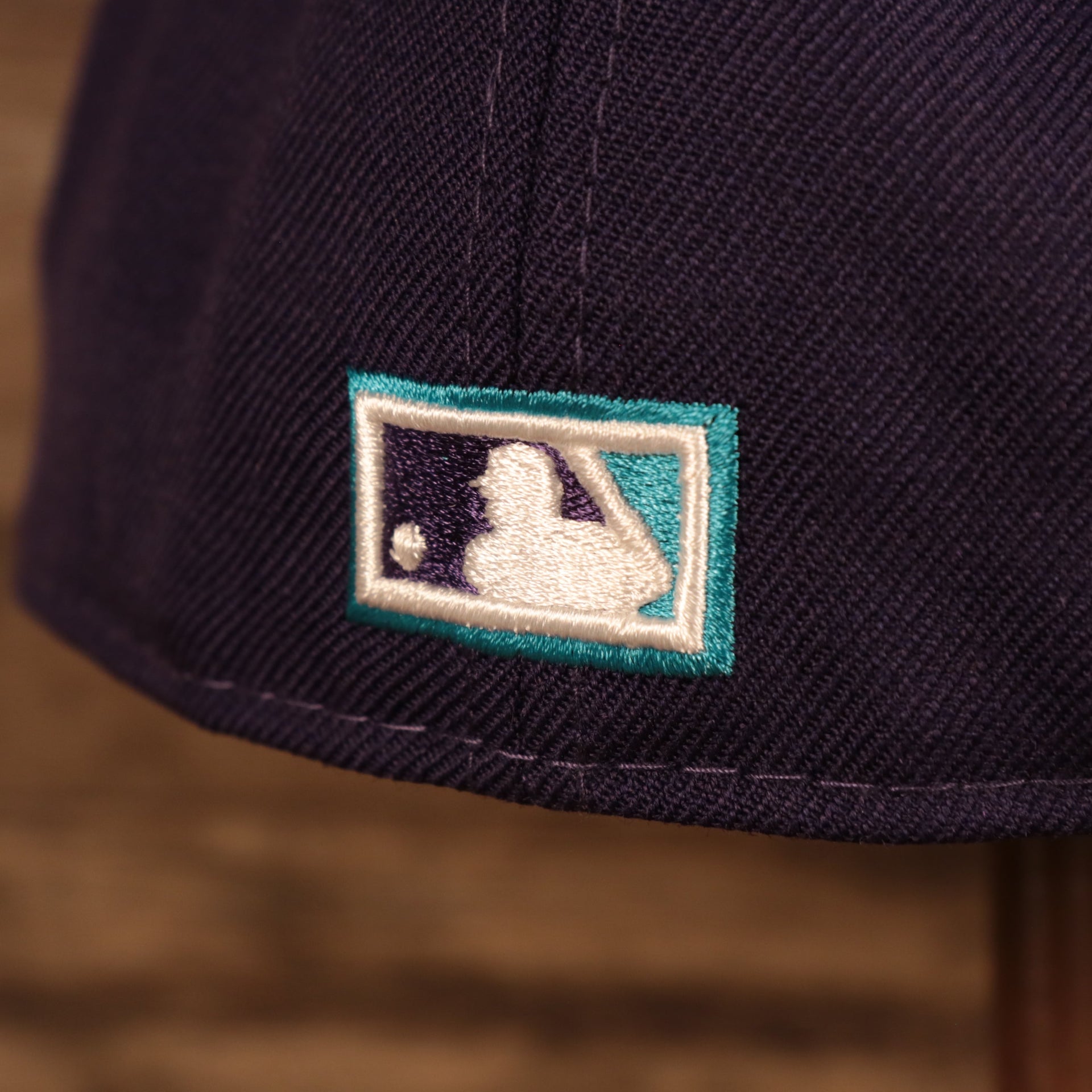Close up of the MLB logo on the back of the Arizona Diamondbacks Upside Down Logo Gray Bottom 59Fifty Fitted Cap