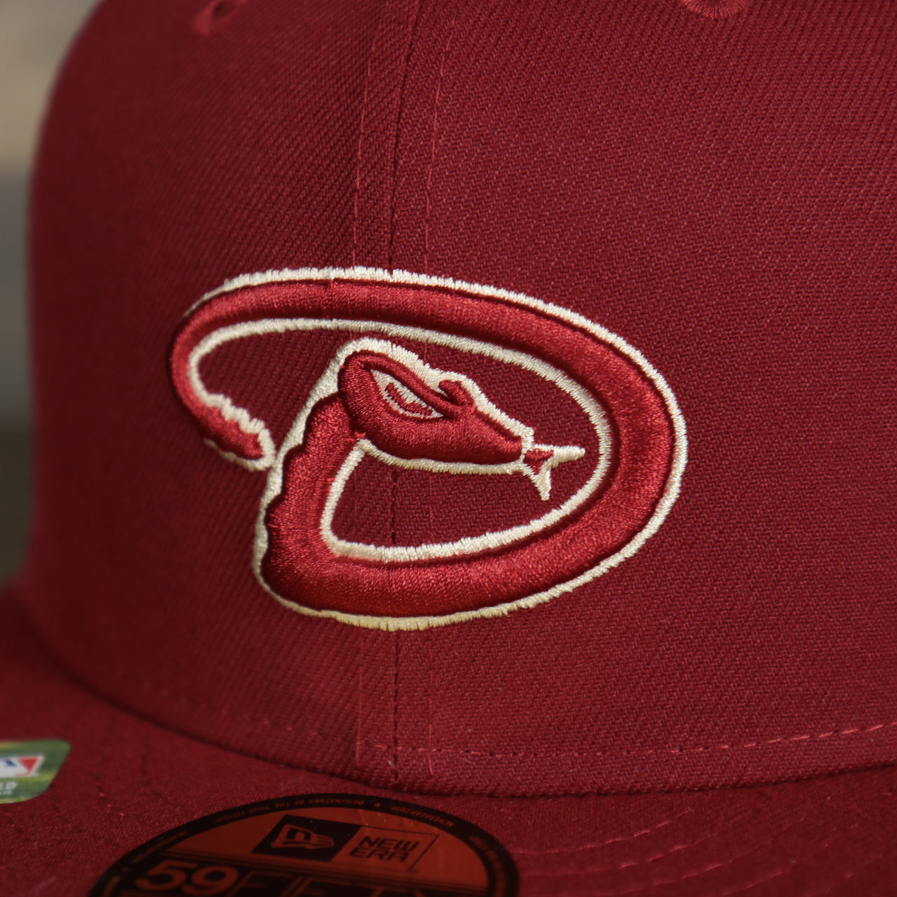 A close up of the Diamondbacks logo on the Arizona Diamondbacks Onfield 2022 Batting Practice 59Fifty Trucker Hat