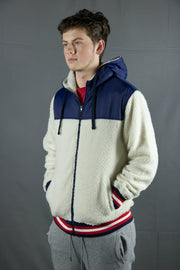 The end of the cuffs and waistband on the sherpa zip up hoodie feature a navy blue, red, and white striped pattern