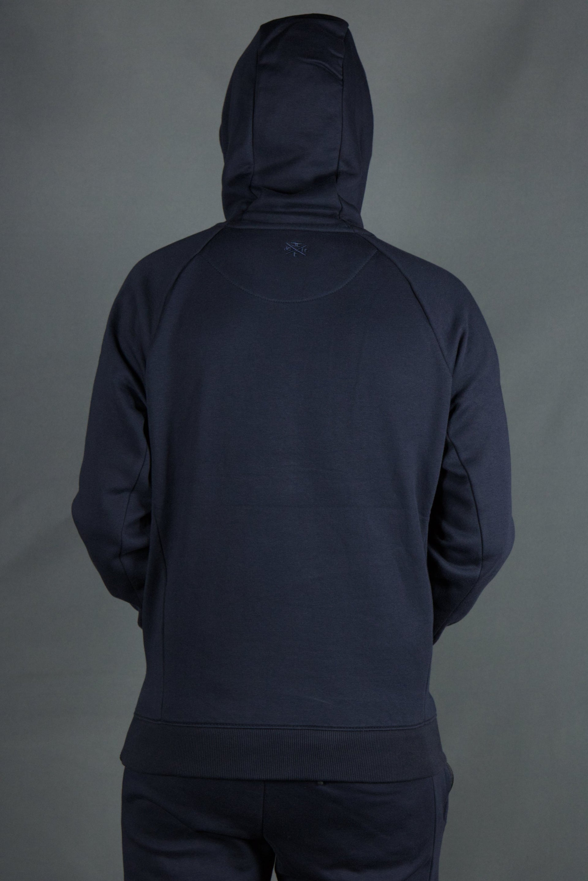The backside of the navy blue Jordan Craig basic fleece pullover hoodie.