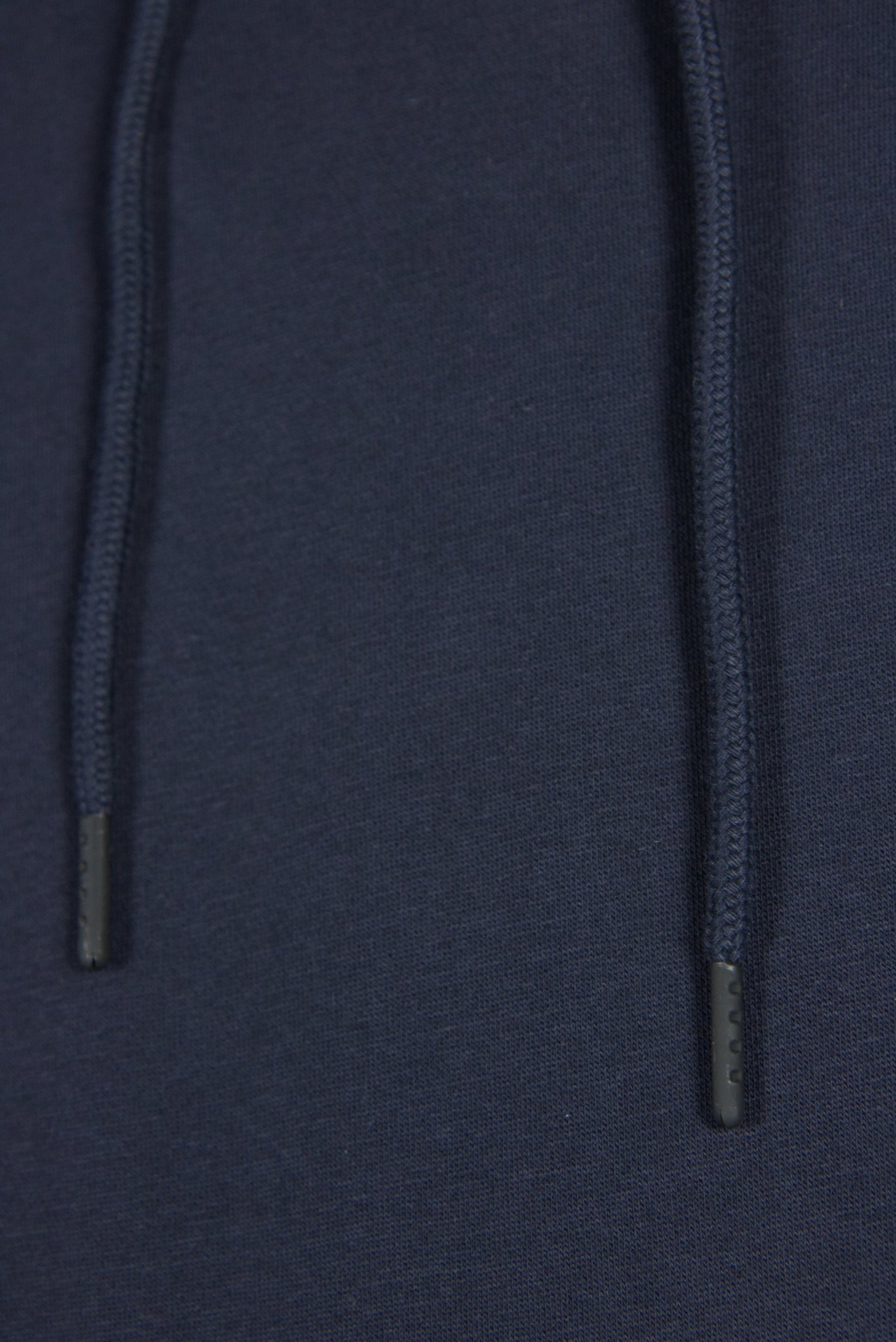 The drawstrings of the navy blue Jordan Craig basic tech fleece pullover hoodie.