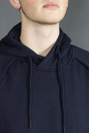 The adjustable hood of the basic tech fleece navy blue hoodie by Jordan Craig.