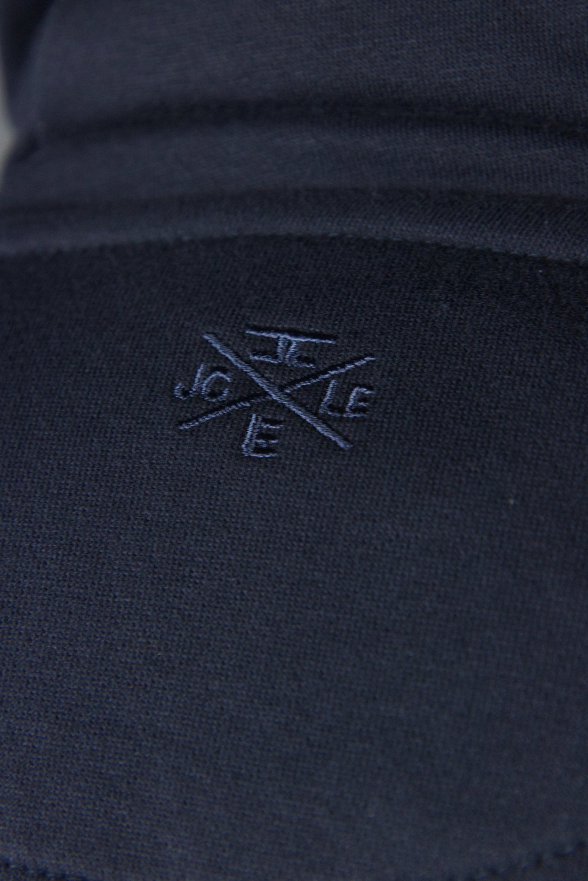 The logo of Jordan Craig on the back side of the Jordan Craig navy blue hoodie.