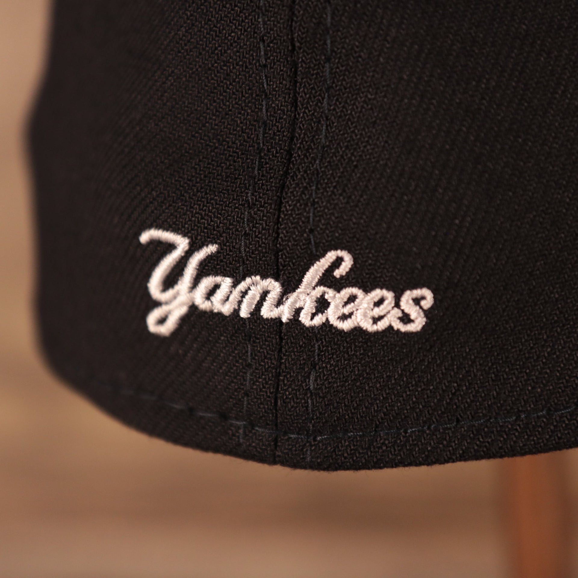 A closeup shot of the Yankees patch on the backside of the New York Yankees 2021 fourth of July navy 39thirty flexfit hat.