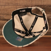 The inside view of the Philadelphia Eagles cream floral baseball cap by New Era.