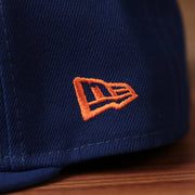 The orange New Era logo on the retro blue all over patch fitted 59fifty.