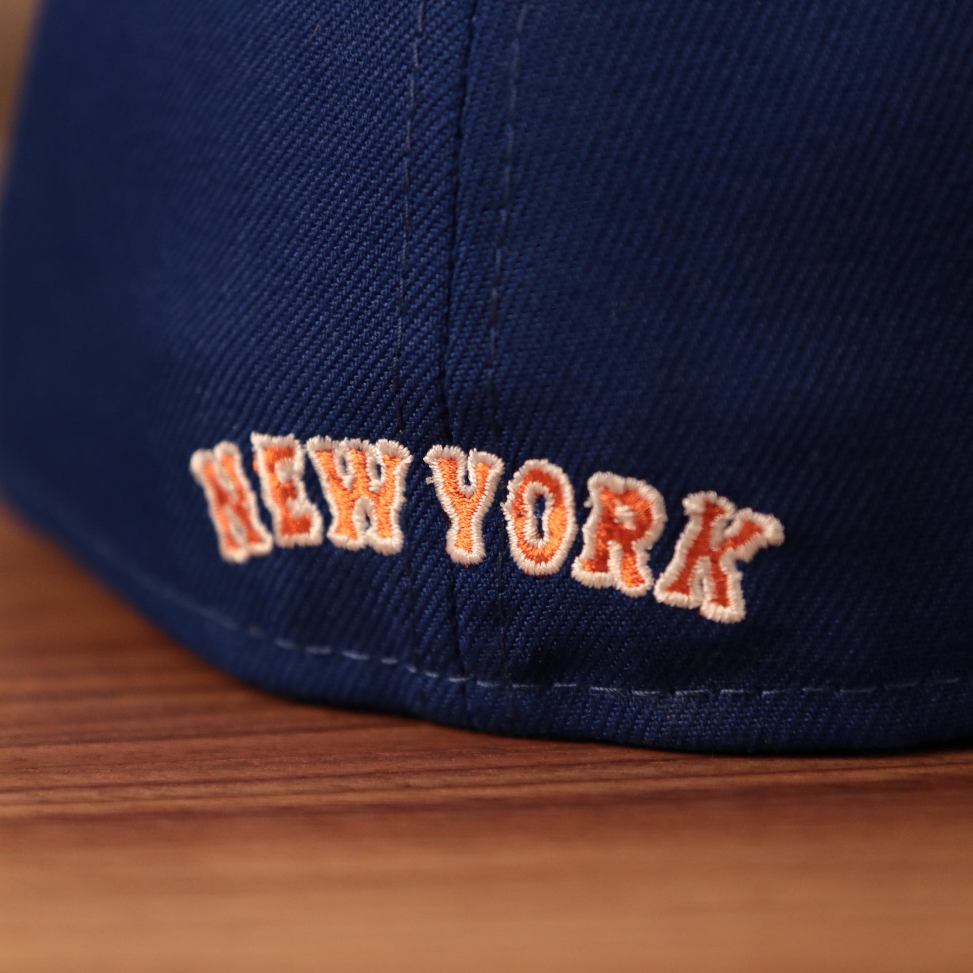 The New York Mets logo on the back side of the blue New Era fitted.