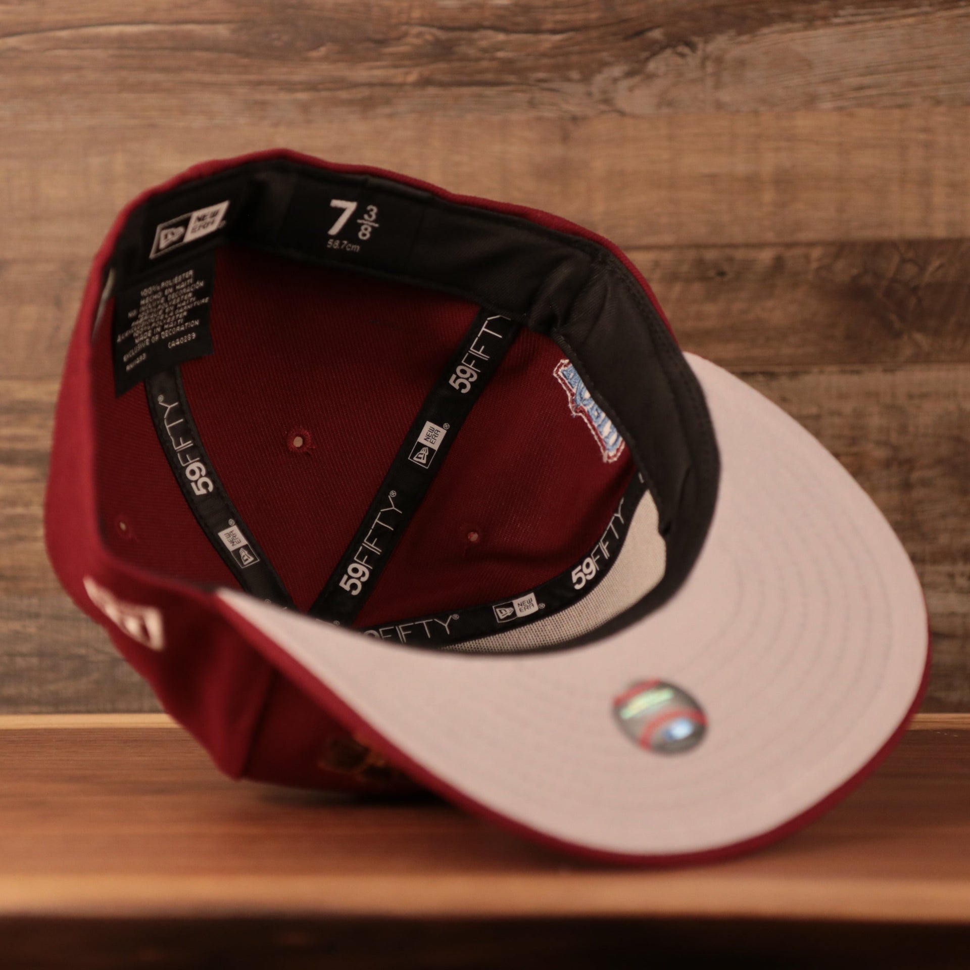 An inside view of the crown of the grey brim fitted Philadelphia Phillies 2008 World Series maroon patch fitted 5950 cap by New Era.