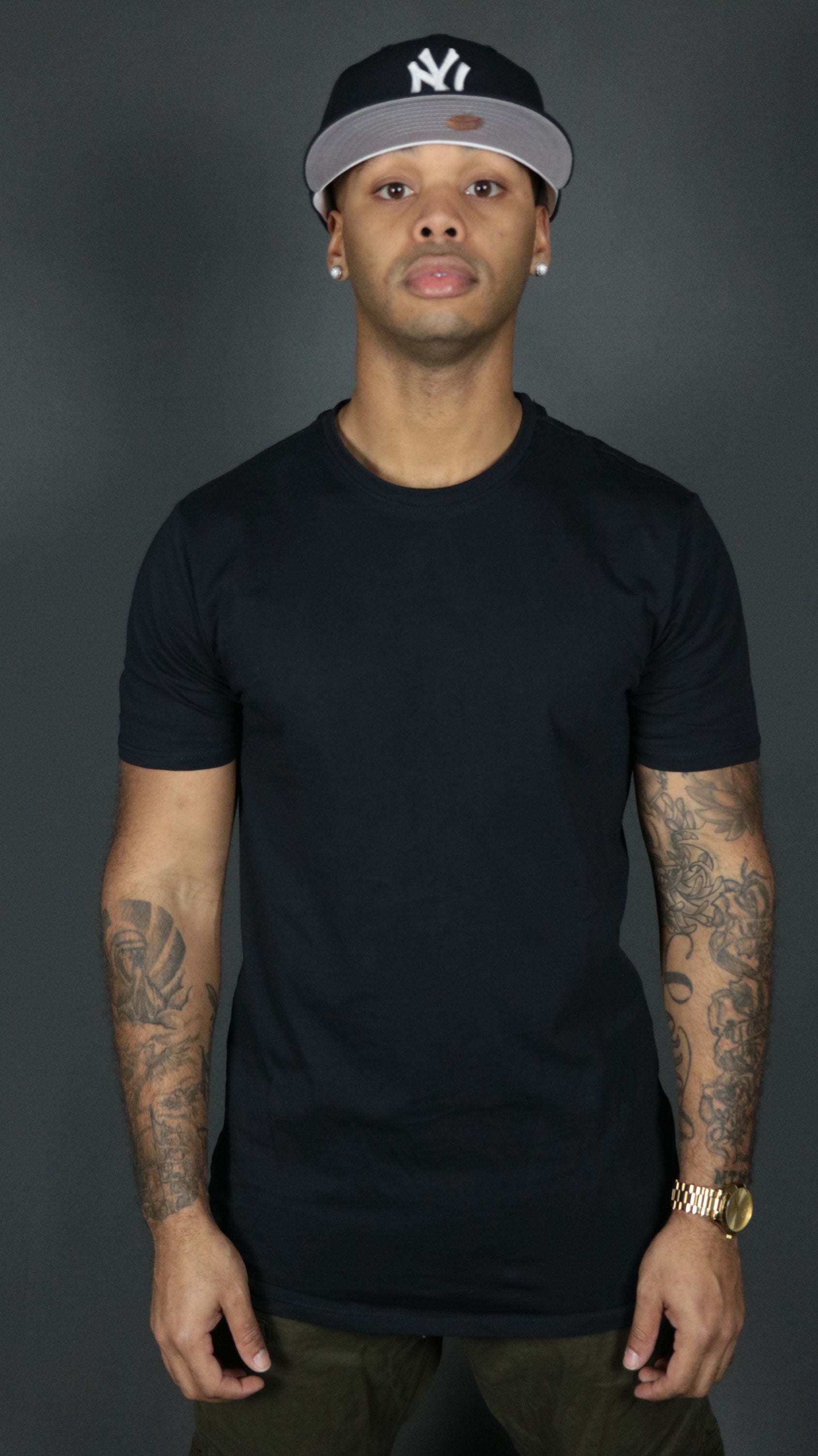 A model wearing the navy Jordan Craig scoop bottom tshirt.