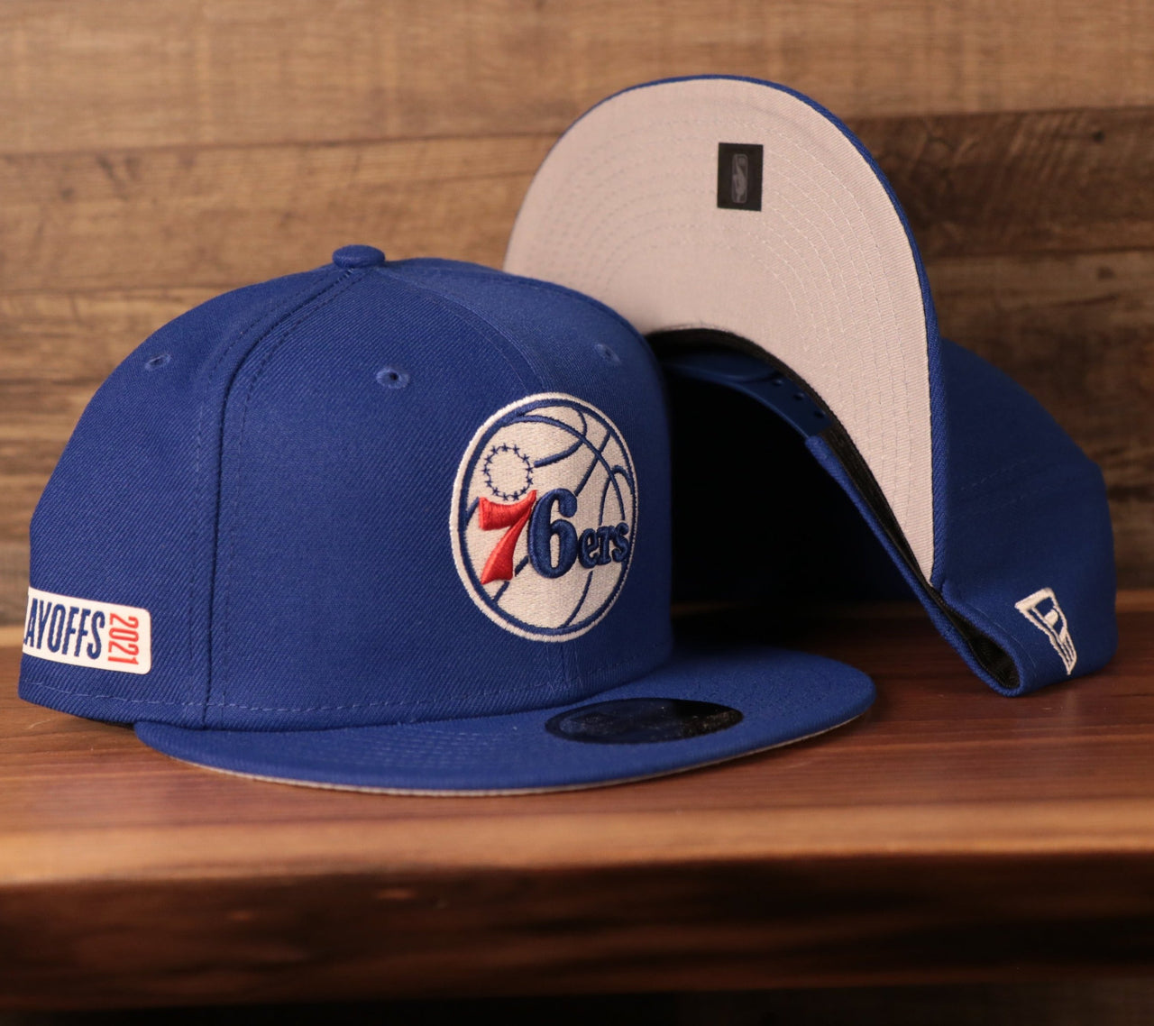 front and bottom of the Philadelphia 76ers 2021 NBA Playoffs Royal Blue 9Fifty Gray Bottom Snapback Hat