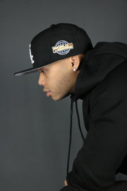 The basic fleece black hoodie by Jordan Craig with a black New Era fitted hat.