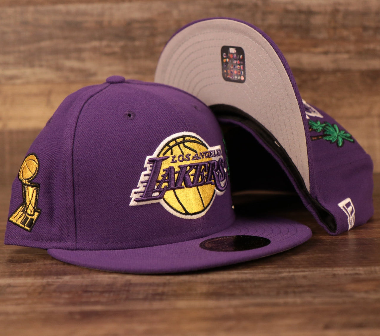 The purple Los Angeles Lakers Larry Obrien Trophy all over patch grey bottom 59fifty fitted hat by New Era.