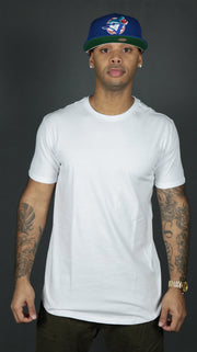 A model wearing the white Jordan Craig hem drop cut longline tshirt.