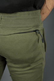 The back zipped pocket of the military green joggers by Jordan Craig.