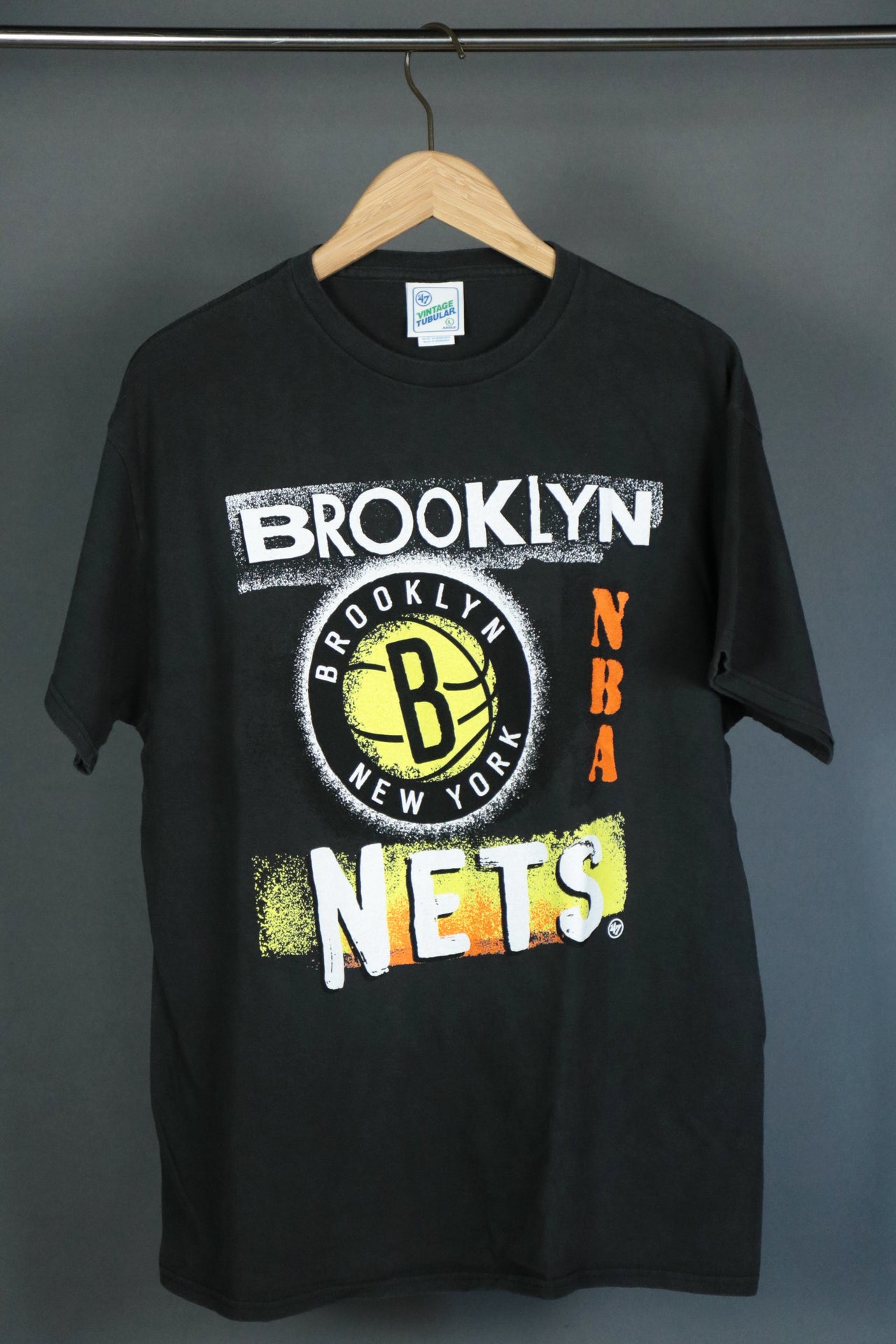 front of the Brooklyn Nets Vintage 90s Washed Print Black T-Shirt