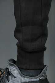 The black logo trim bottom tech fleece sweatpants by Jordan Craig.