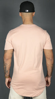 The longline hem drop cut design of the pink Jordan Craig longline shirt.