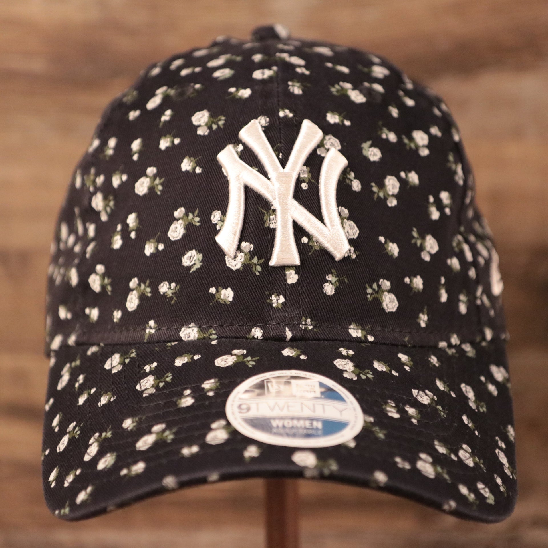 The New York Yankees logo patch on the front side of the New Era floral baseball cap.