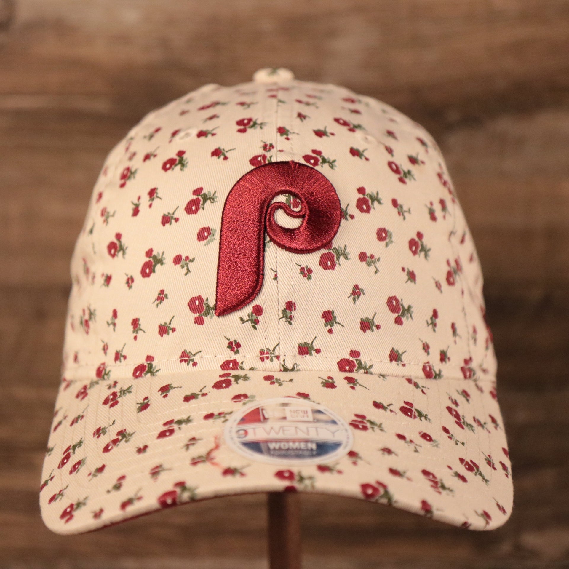 The cooperstown Philadelphia Phillies logo on the front side of the cream youth micro floral 920 dad hat by New Era.