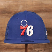 The logo of the Philadelphia 76ers on the front side of the royal blue New Era trucker hat.