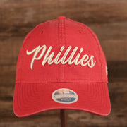 The Phillies women team script logo on the front side of the washed pink womens baseball hat.