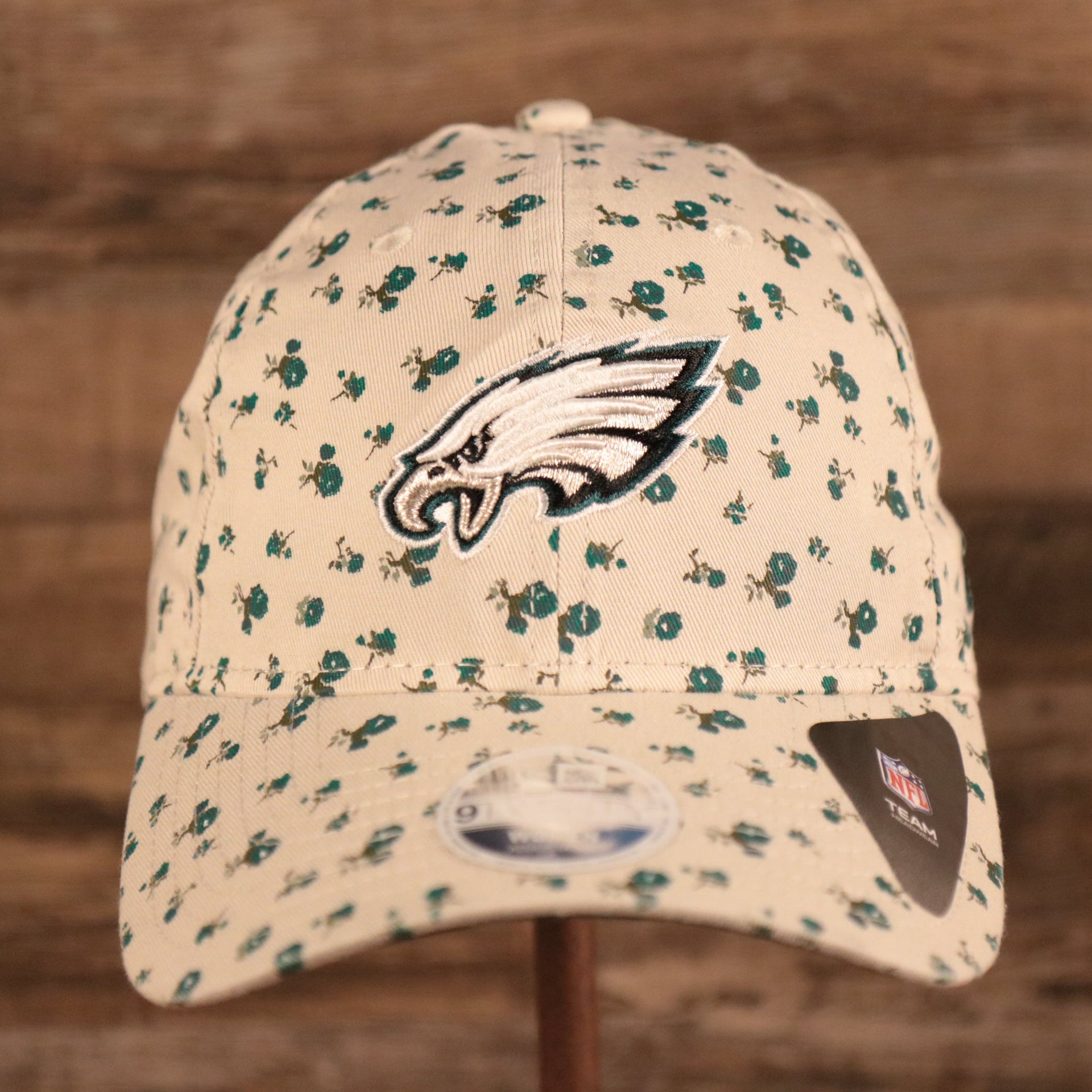 The Philadelphia Eagles logo on the front side of the New Era youth micro floral baseball 9twenty dad hat.