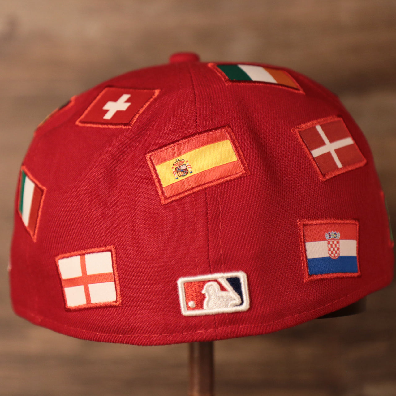 the back of this cap has flags from the countries of Croatia, Ireland, and Switzerland Phillies World Flags Gray Bottom Fitted Cap | Philadelphia Phillies International Flags Red Grey Under Brim Fitted Cap