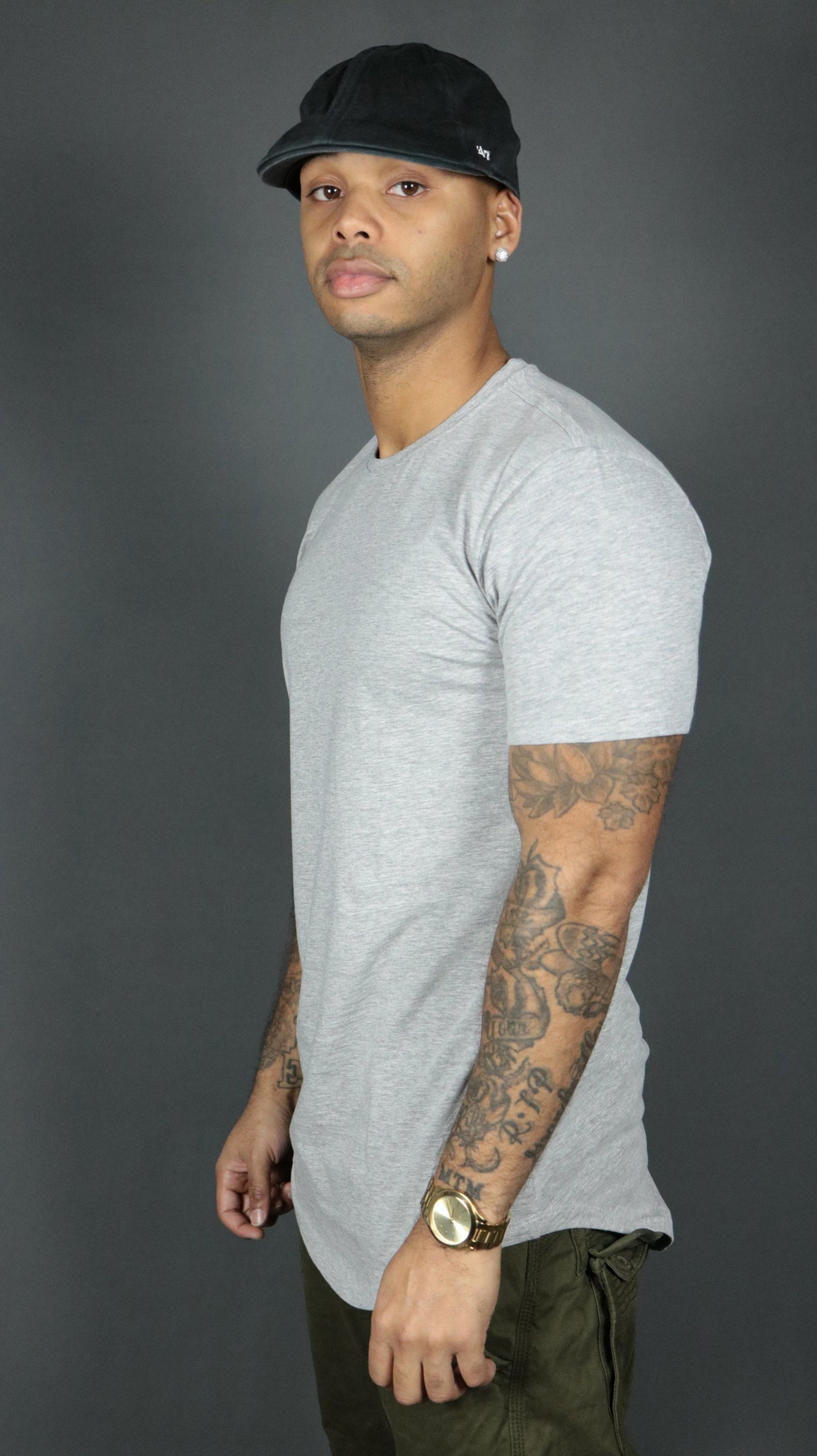 A model wearing the grey Jordan Craig longline t shirt with curved hem.