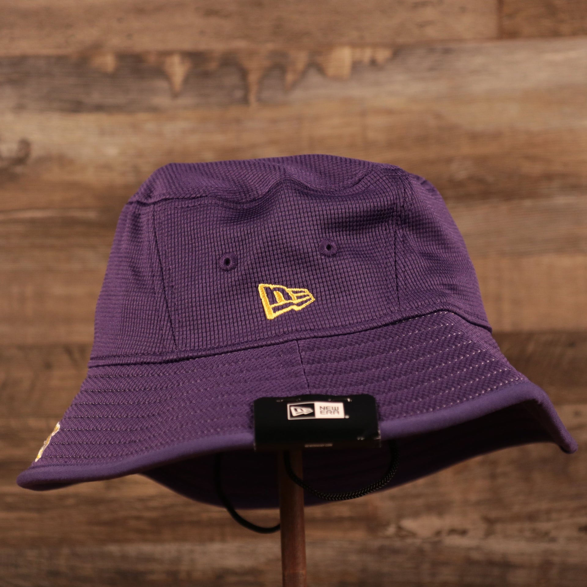 The New Era logo patch on the purple Los Angeles Lakers boonie hat.