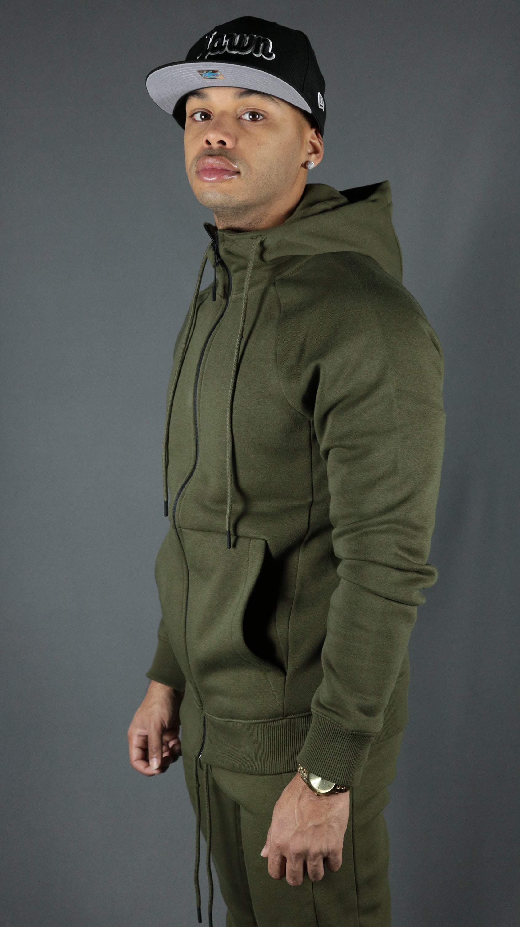 The olive military green Jordan Craig tech fleece hoodie worn by a model.