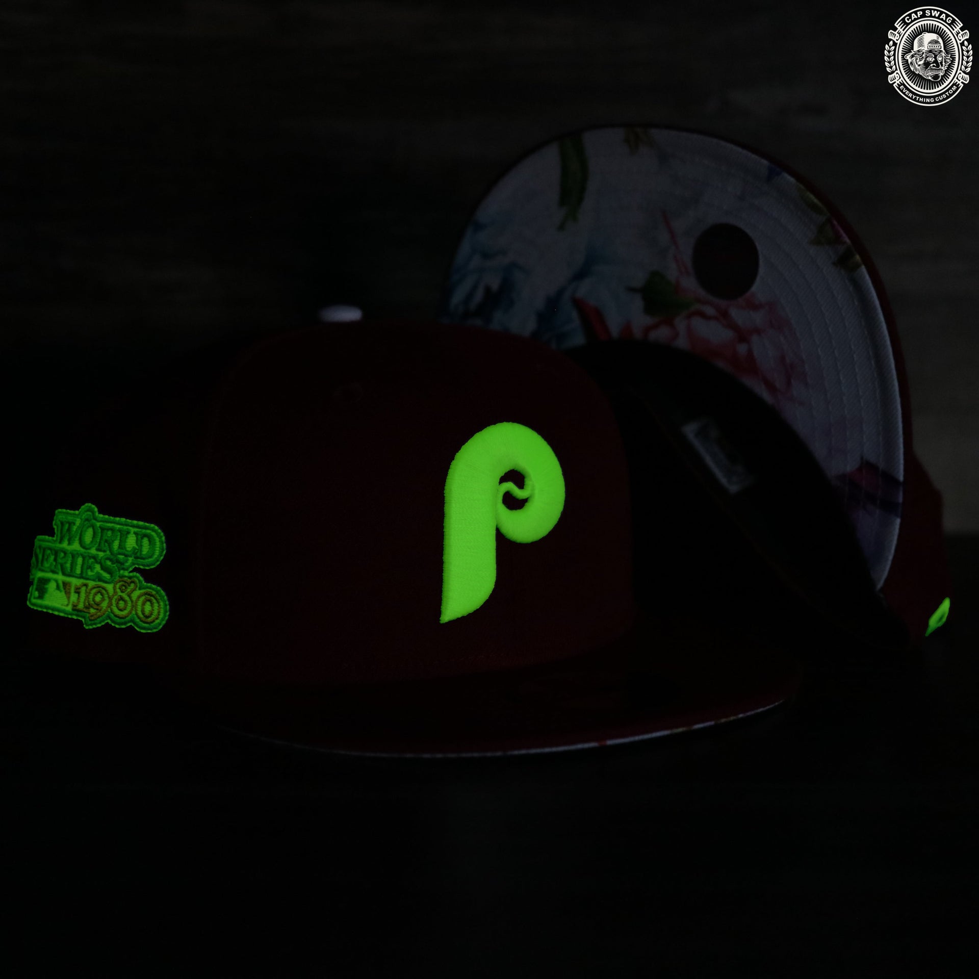 The green Philadelphia Phillies retro logo on the front side of the glow in the dark 59fifty fitted floral underbrim cap.