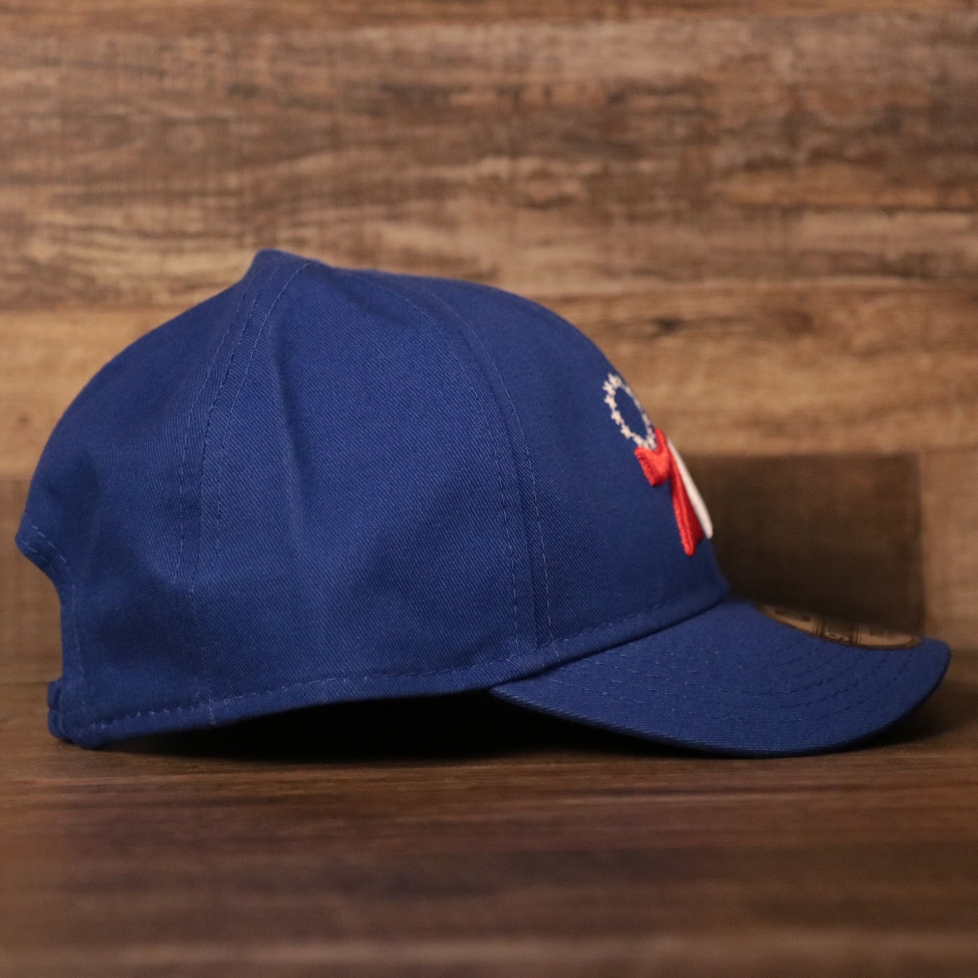 The right side of the royal blue Philadelphia 76ers kids 9twenty dad hat by New Era.