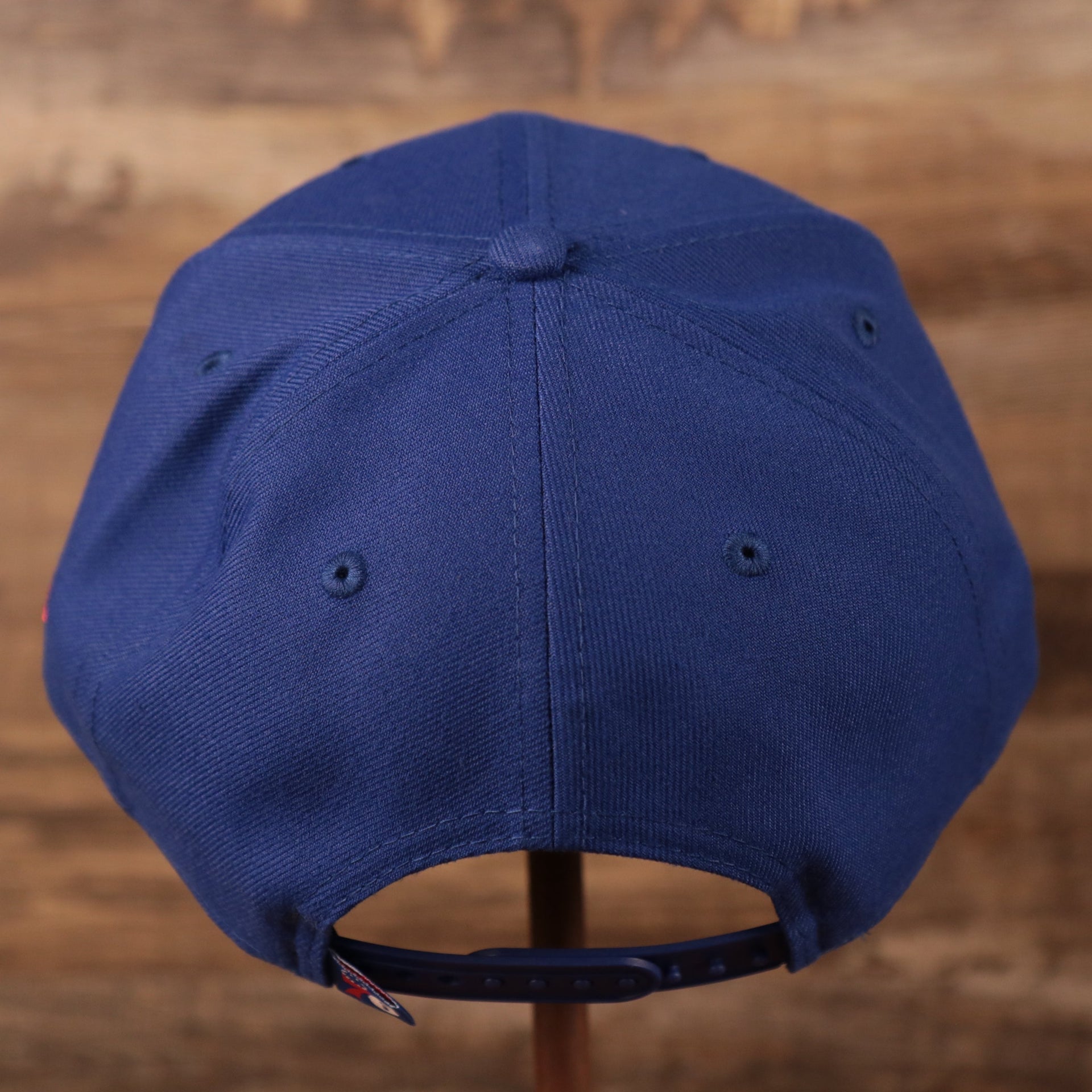 The adjustable stap of the youth royal blue Philadelphia 76ers logo tear 9fifty hat.