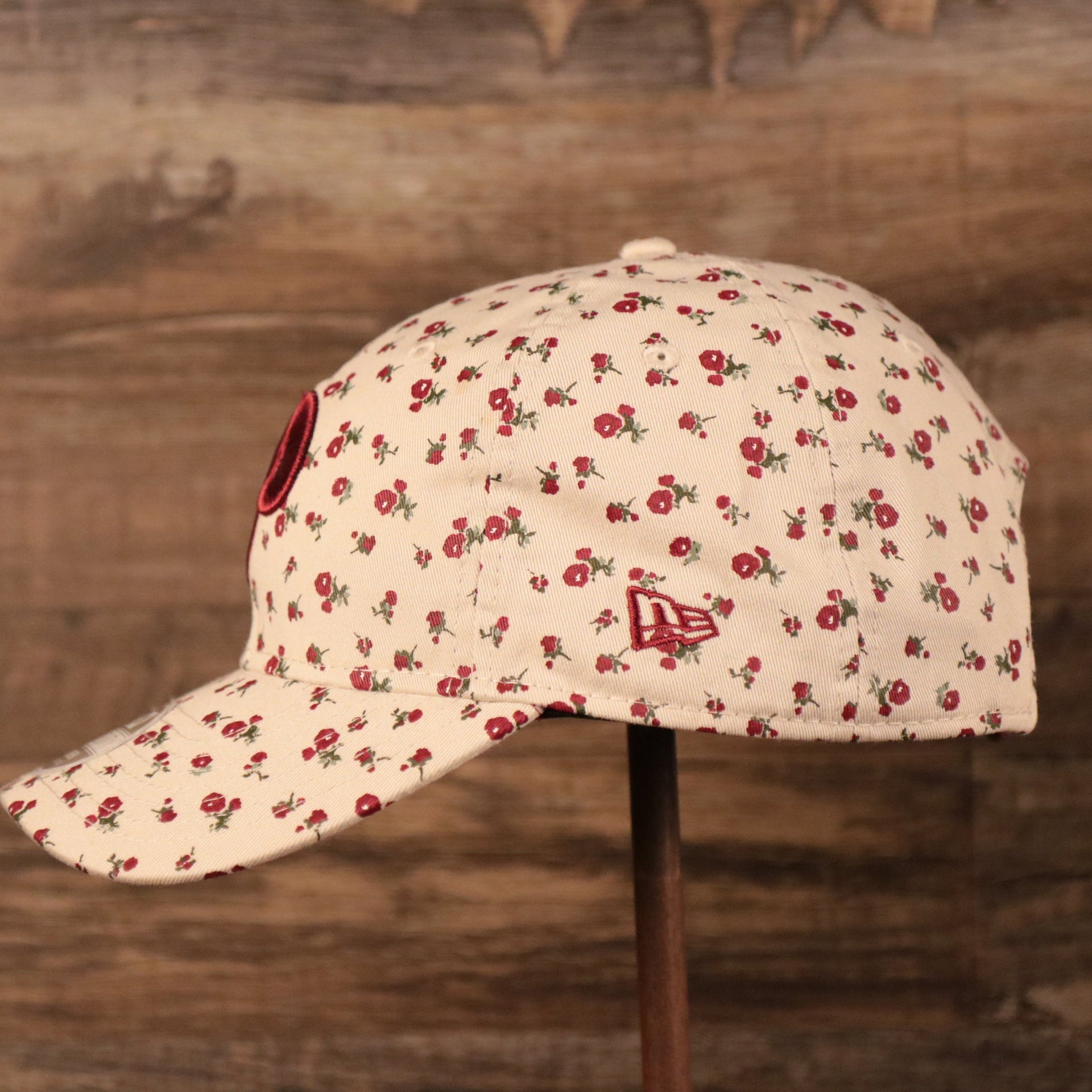 The left side of the Phillies cream youth micro floral dad hat has the logo of New Era.