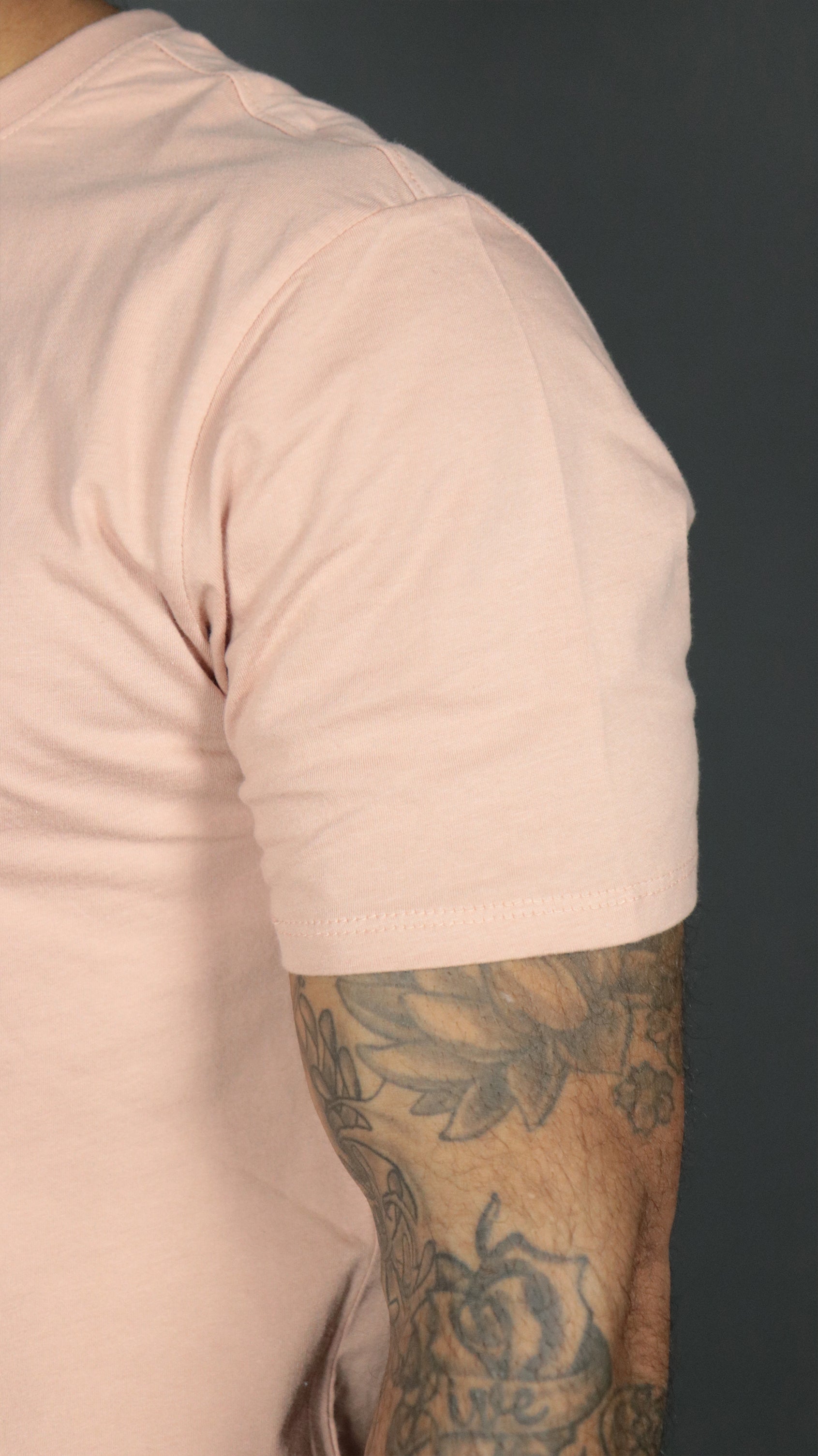 Left shoulder of the pink Jordan Craig longline scoop bottom t shirt.
