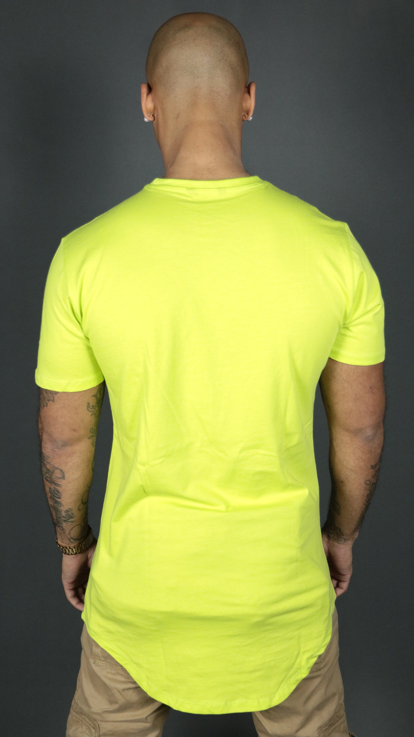 The scoop bottom of the Jordan Craig yellow longline tshirt for men as seen from the back.