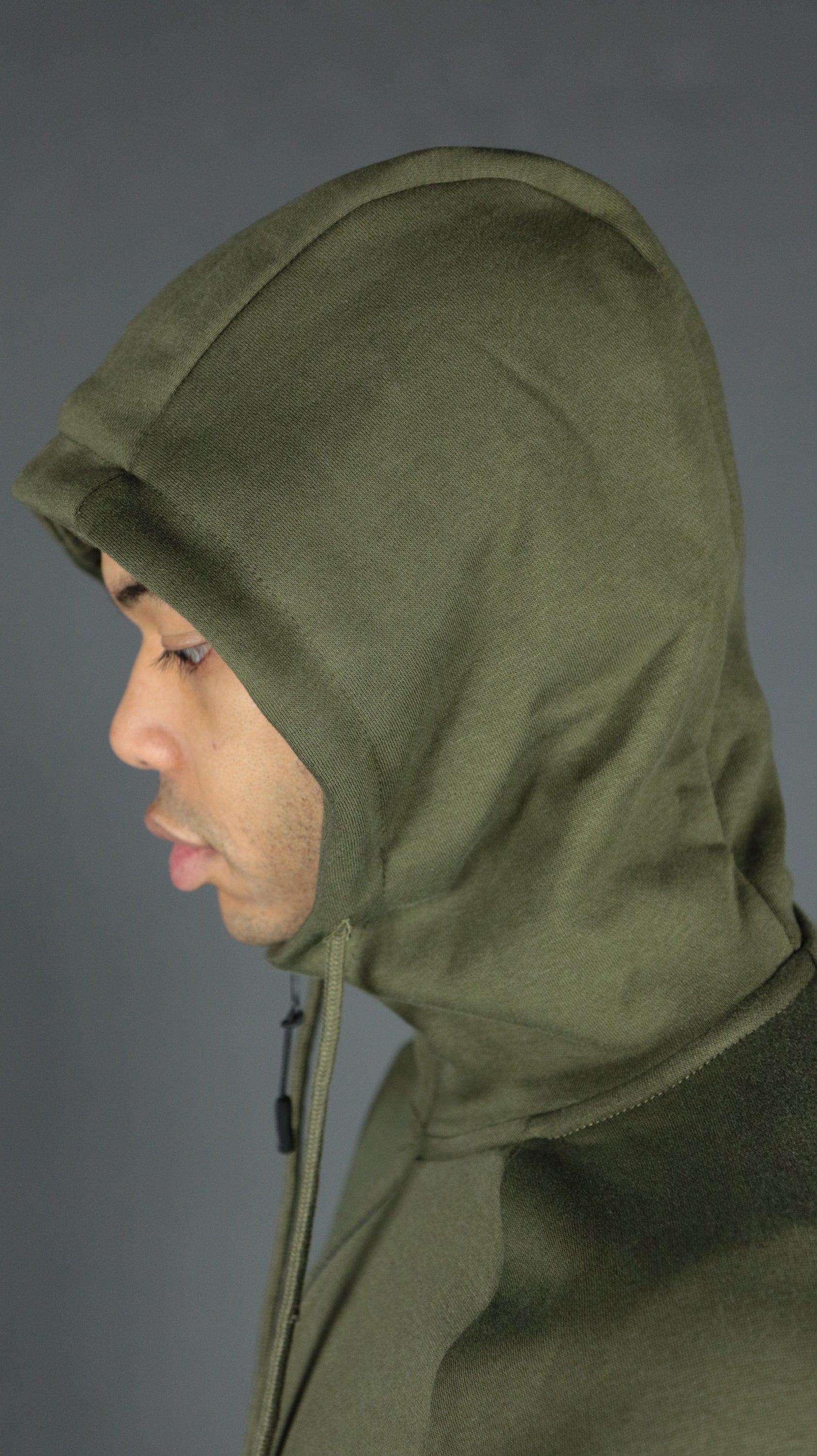The three panel fabric hood of the olive military green Jordan Craig basic tech fleece zipup hoodie.