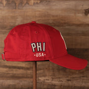 The PHI USA patch on the wearer's right side of the red MLB fourth of July 2021 Philadelphia Phillies 920 dad hat.