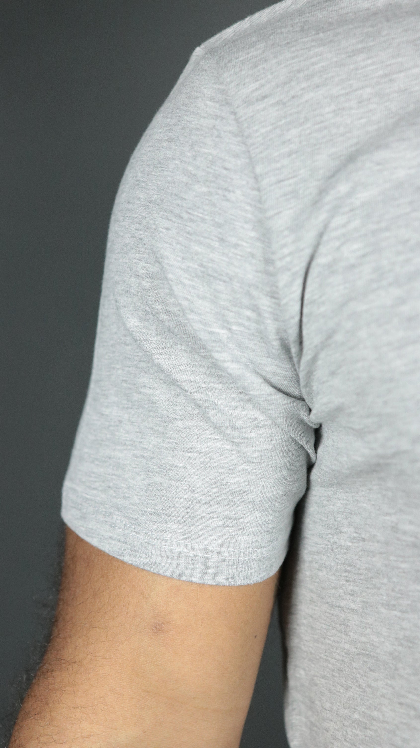 The right shoulder of the grey Jordan Craig longline scoop bottom tshirt mens.