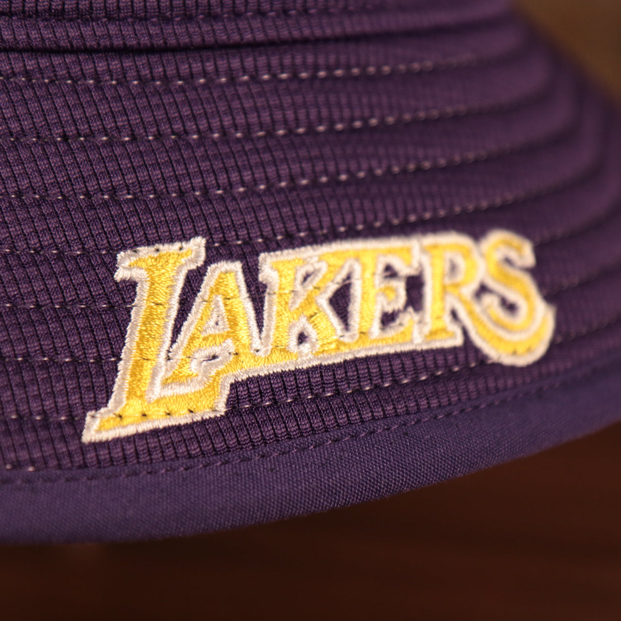 The purple Los Angeles Lakers script brim NBA bucket hat by New Era.