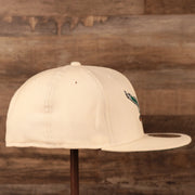 The right side view of the Philadelphia Eagles cream retro kelly logo with green brim 5950 fitted cap by New Era.