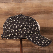 The wearer's right side of the Yankees women micro floral cap.