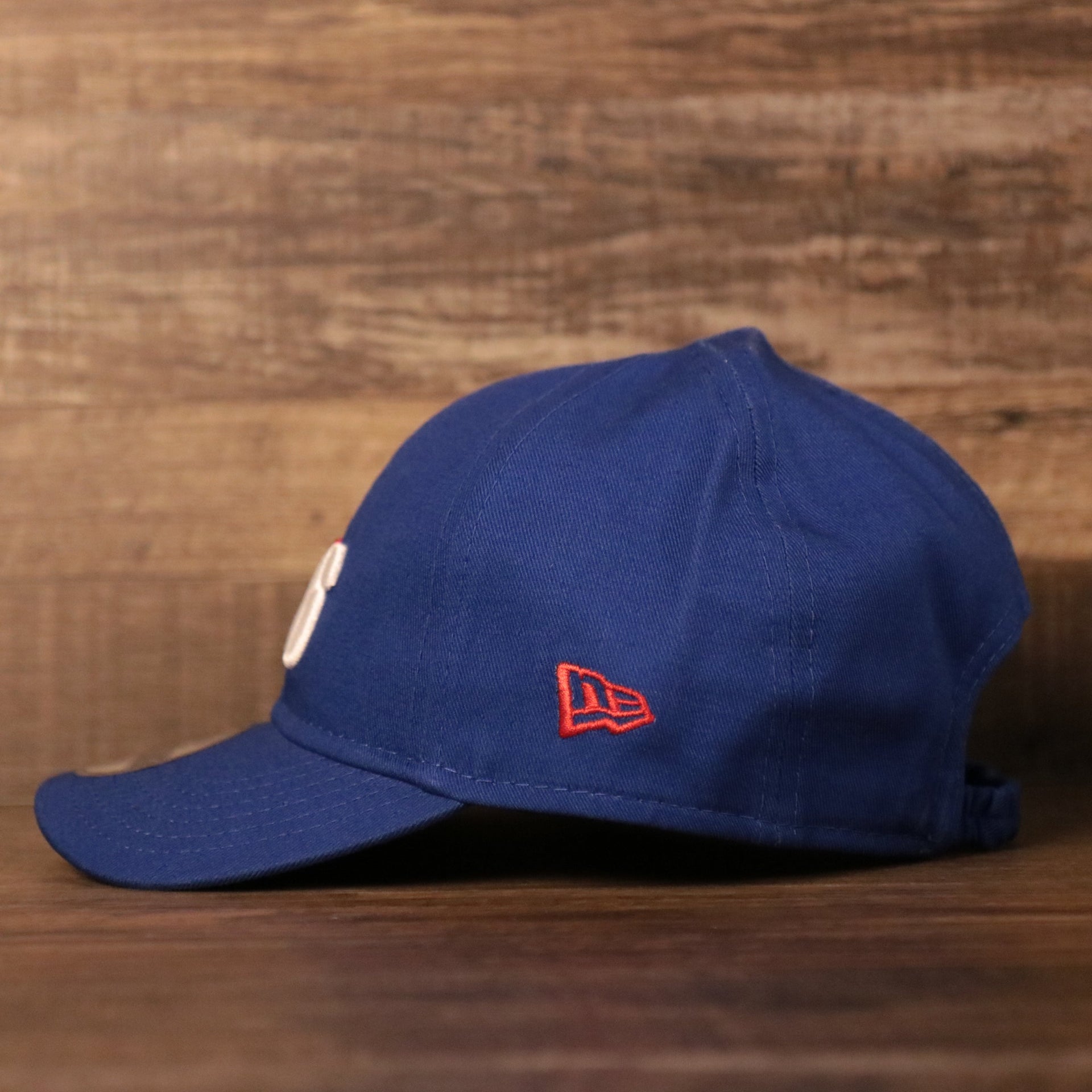 The New Era patch on the left side of the royal blue sixers toddler ball cap.