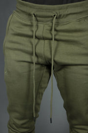 The drawstrings of thie military green Jordan Craig jogger set to support the banded hem.