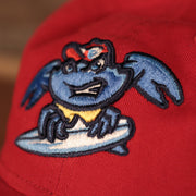A closeup of the Jersey Shore BlueClaws (aka Lakewood BlueClaws) logo that is embroidered on the front of the red 9Twenty dad hat.