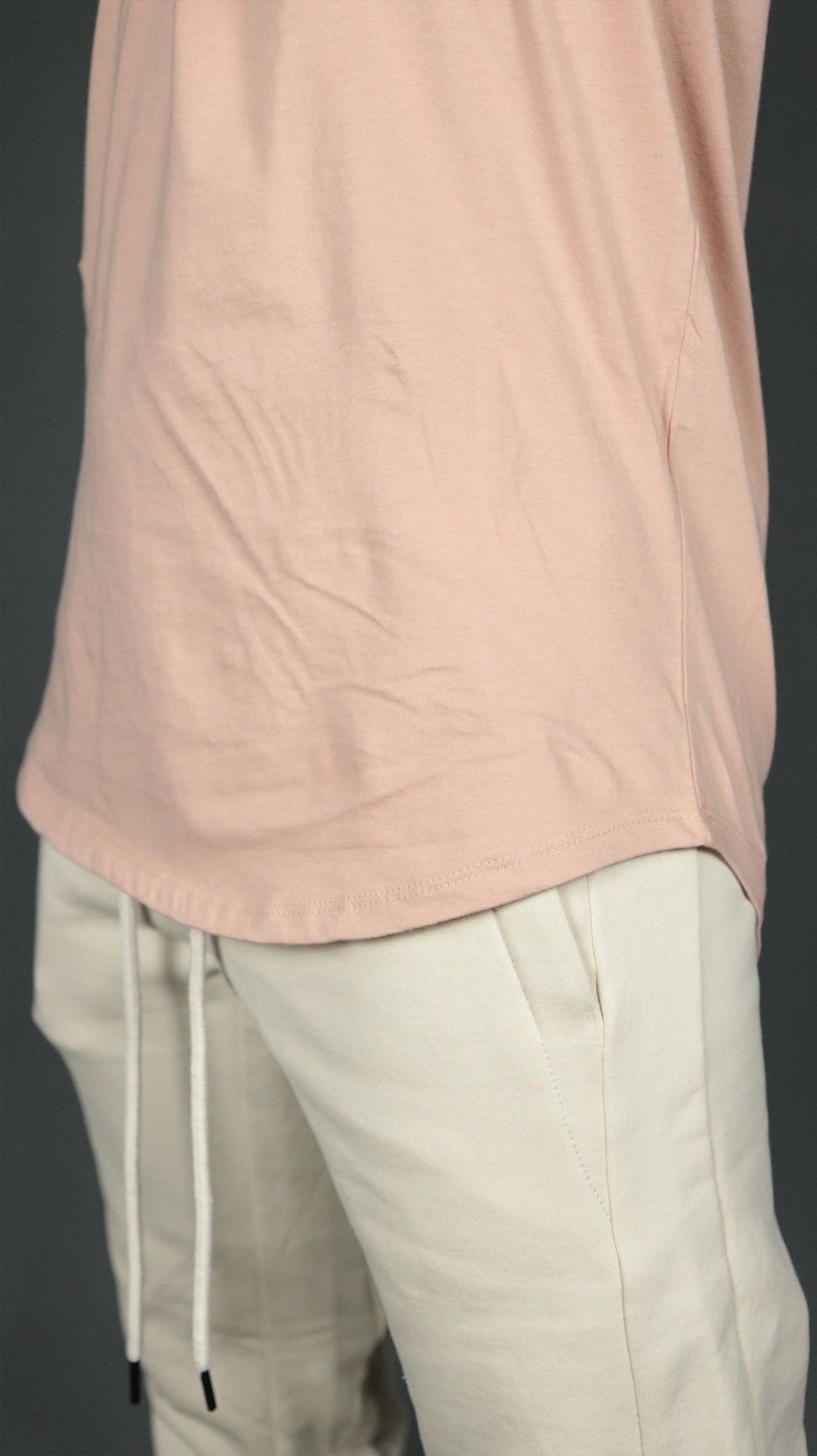 The scoop bottom of the pink men's longline t-shirt by Jordan Craig.