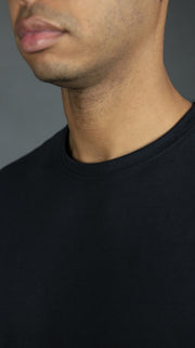 The front collar of the navy Jordan Craig men's scoop bottom tshirt.