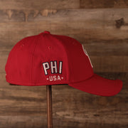 The PHI USA patch on the wearer's right side of the red MLB fourth of July 2021 Philadelphia Phillies 3930 flexfit hat.